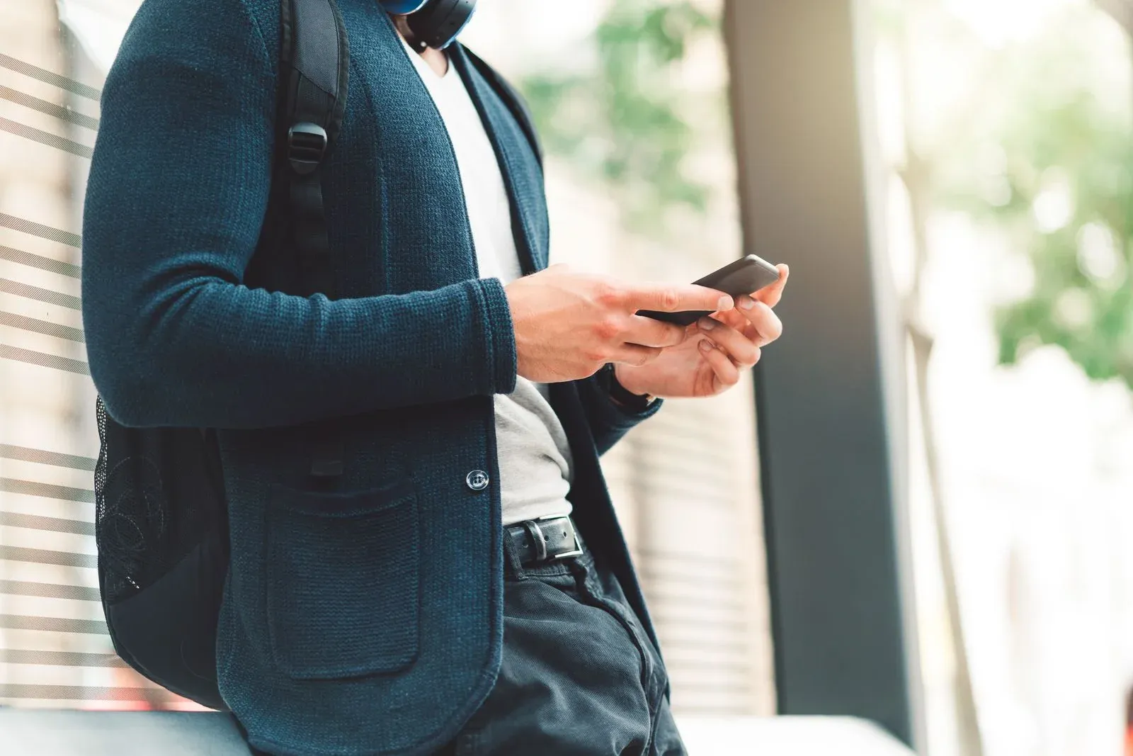 man holding the phone and silencing unknown callers